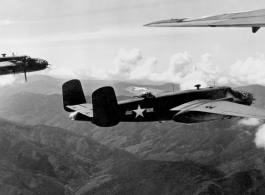 B-25s of the 22nd Bombardment Squadron in flight over rough mountains of SW China or Burma during WWII.