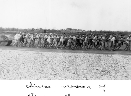 Chinese workers pulling a concrete roller at a field in China, probably in Hunan Province or Guangxi Province. During WWII.