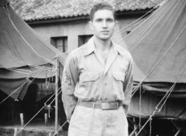 Sgt. David Axelrod, was in the 23rd Fighter Control Squadron from January to August, 1945, stationed at its headquarters at Luliang Airbase, Yunnan, China.  Here he is standing in front of the headquarters tents and building.  