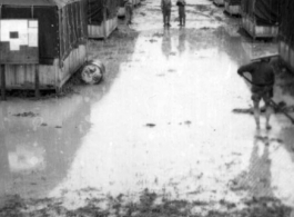 Tent city of flooded living quarters at Liangshan. Stream next to the site has overflowed in this image. During WWII.