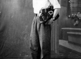 A  young Chinese man poses for photographer during WWII.