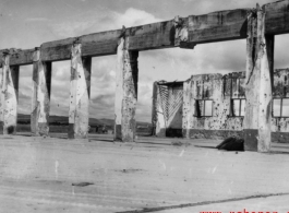 Bob Riese and friend explore remains of aircraft factory and hangers at the air base at Liuzhou, in 1945. The facilities at the base were first destroyed by the Chinese and Americans during retreat in the face of Ichigo during the fall of 1944, then may have been destroyed more by American bombardment during Japanese occupation, and possibly destroyed more by the Japanese as they retreated the area in 1945.