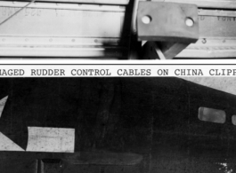 Flak damage to the B-24 "China Clipper" as photographed after the fact by Hal Geer, who had also been holding a camera on the plane at that location, at the waist window, when the plane was hit in flight, and the camera in his hands (and held to his face) had been destroyed by the flak, saving his life at the same time.