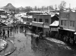Street scene on a snowy day in China during WWII, probably in Guangxi province.  From the collection of Hal Geer.