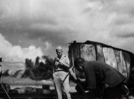 In Liuzhou, Guangxi.  Train in the background burned after Japanese bombing on September 27, 1944.  In the foreground Col. Richard Wise (AGFRTS) takes stock.  According to Hal, Col. Wise was somewhat unconventional, and on at least one occasion made a parachute jump without the proper gear (proper shoes), and was bawled out by Chennault.