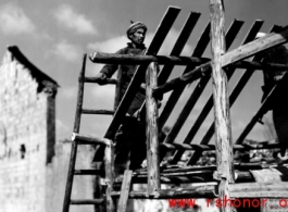 Man building roof of house in SW China during WWII.