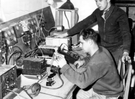 Men work on radio equipment at a base in China.  Image from U. S. Government official sources. 