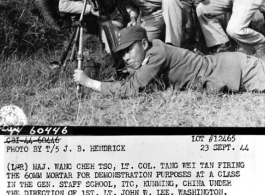 (L-R) Maj. Wang Cheh Tso, Lt. Col Tang Wei Tan firing the 60mm mortar for demonstration purposes at a class in the general staff school, ITC, Kunming, China, under the direction of 1st. Lt. John W. Lee, Washington, Iowa. 23 September 1944.