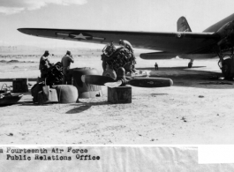 Maintenance under a blue China sky. No fancy hangers or white coveralls for this job. Line men from the 14th Air Force transport unit pull an overhaul under the wing of a C-47.