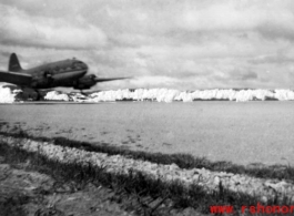 A C-46 on a runway in the CBI.  Interestingly, a censor has scratched out the mountains in the background.   From the collection of Robert H. Zolbe.