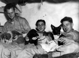 Hanging out, probably at Yangkai base, Yunnan.  Jay Rosencrantz, on the right, holds pet 'Clarance'.  Although called to be men at war, these soldiers were still young, and a boy's best friend was still a comfort and friend even during war.  Joseph Siana in middle.