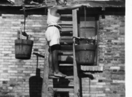 "Filling water buckets for showers" at an American air base in the CBI.