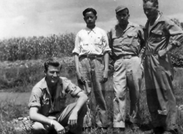 Left to right: Unknown, houseboy, Robert Zolbe, and unknown pose in front of corn field in the CBI. During WWII.