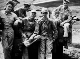 "Mission time." American flyers prepare themselves for another mission during WWII. Note the parachutes at the ready on the ground.