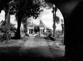 Looking at a bridge through a city gate onto a small bridge over a canal, in Yunnan province, China. During WWII.