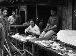 A pork seller in a village market in Yunnan province, China. During WWII.