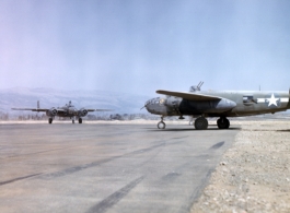 B-25 'Mitchell' bombers of the Ringer Squadron perform engine checks prior to taking off on a mission. These three aircraft (nose wheel of third is visible underneath #450, on the right) are on the runway at Yangkai AB, in Yunnan province, China.
