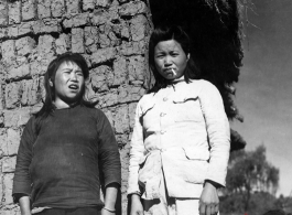 Local women in China during WWII: These are likely to be wives of officers, billeted to live in the village, rather than women who grew up in the village. They also might be prostitutes, following the troops. 