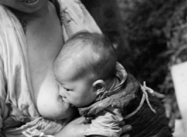 A mother and nursing baby in Yunnan province, China, during WWII.