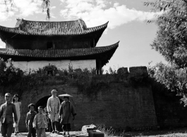 Local people in China in front of a town gate near Yangkai, Yunnan.  From the collection of Eugene T. Wozniak.