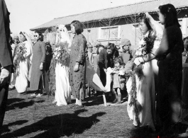 A group wedding in Yunnan province, China, during the hard war years of WWII.  Many of the grooms would have been soldiers and group weddings really came into style at around or just before the war years.