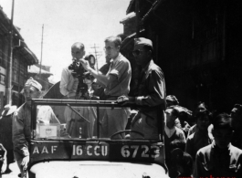 Americans in Jeep shooting movie film in a Chinese town, probably Kunming.