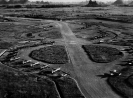 P-51s, L-6s, and other planes at the Liuzhou (Liuchow) air base during the summer or fall of 1945.  The distinct karst mountains of the area are visible in the background.  Photos taken by Robert F. Riese in or around Liuzhou city, Guangxi province, China, in 1945.