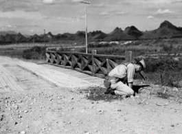 An American preparing for demolition work during the evacuation before the Japanese Ichigo advance in 1944, in Guangxi province.  Selig Seidler was a member of the 16th Combat Camera Unit in the CBI during WWII.