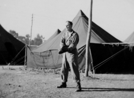 GI with mitt playing baseball at a tent city in Kunming, China, during WWII.