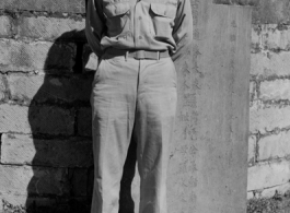 "T. T. Hale in front of a Chinese Cemetery"-- The gravestone behind is for the Ni family, erected 1877, during the Qing dynasty (Guangxu period).  In southwest China during WWII。