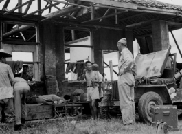 16th Combat Camera Unit filming Chinese workers injured in a fall while repairing roof of hostel building in southwest China during WWII.