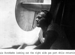 Dale Stronbehn looking out the right side gun port while returning from a flight over India in 1944.