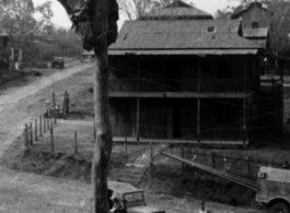 Two linemen putting finish on line from Ledo-Burma Road junction to Allied communications HQ at Lashio, Burma, in 1945, with two technicians up on pole working.