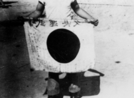 George M. Corrington display a  shows off trophy captured Japanese Good-Luck Flag  (寄せ書き日の丸) he picked up at battlefield at Kohima.  Photo by Tom D. Davis.