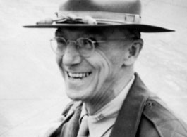 Joseph Stilwell smiles in front of an airplane in the CBI during WWII.