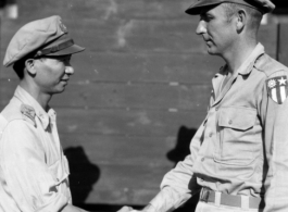 A handshake between unknown Chinese and American military personnel. In the CBI during WWII.