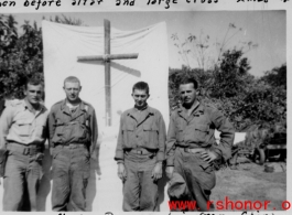 For men of Mars Task Force (124th Cavalry) stand before alter and large cross in Christmas, 1944, at Naylon, Burma, six miles from China.