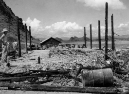 Gas straining station after Japanese air raid. Karst hills in the background hit that this is likely a US base in Guangxi province, China, either at Liuzhou or Guilin.