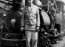 A GI rides a narrow-gauge train engine. In the CBI during WWII.  Photo from Walter De Blair.