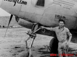 A man poses before the F-5 (a variant of the P-38) 'Mary Ann' piloted by Major H. T. Bailey, who had a crew chief "Snaffy".  Serial #43-26291.