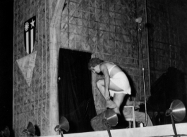 Cross-dressing GI removes an article of clothing while the band Jive-o-Lieps plays music in the CBI during WWII. 54th Air Service Group.