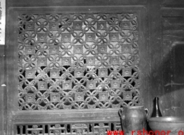 A carved wooden door screen in China. During WWII.  From the collection of Frank Bates.