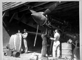 The line crew working on a Curtiss P-40 in a hanger at Kunming, China. 15 September 1942.