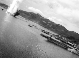 B-25 Mitchell bombers--flying at a very low level--attack a  tidy harbor somewhere in SW China, Indochina, or Burma during WWII.