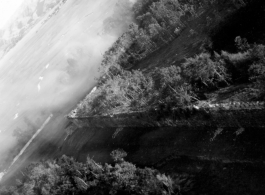 Smoke drifts over Tengchong city wall after B-25 Mitchell bomber attacl during battle with Japanese ground forces, flying over Tengchung (Tengchong), near the China-Burma border in far SW China.