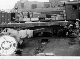 September 27, 1944  During WWII, Chinese artillery piece waiting on a siding near a refugee packed railroad yard at the south station, Liuchow, China.  Photo by Lt. N. J. Dain