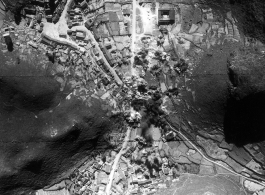 In these three images, we see a small town in Guangxi Province, SW China, being bombed by American B-25 bombers. In the succession of images we see the progress of the bombing.   In the first image, just as the first bombs hit, one can see a few trucks of a Japanese convoy sparsely about the town, and a few people milling or running around (see blown up image below). Most likely these are exclusively Japanese soldiers, as usually Chinese civilians would flee towns in front of the Japanese whenever they coul