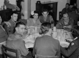 Celebrities visit and perform at Yangkai, Yunnan province, during WWII: GIs and medical staff share a meal with celebrities, including Betty Yeaton.