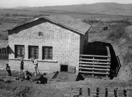 Workers outside a beef slaughterhouse at Yangkai, set up specifically to provide meat for base personnel. During WWII.