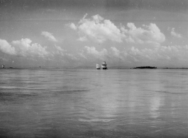 Boats with sails underway in India.  Scenes in India witnessed by American GIs during WWII. For many Americans of that era, with their limited experience traveling, the everyday sights and sounds overseas were new, intriguing, and photo worthy.